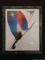Framed abstract painting signed by the artist with bold colors and diagonal black line.