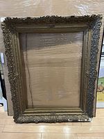 Full view of the large antique frame showing overall shape, size, and style.