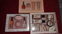 Three unopened gift sets: Chantilly perfume set with lotion and soap; Chloe moisturizer set; Honey Ginger bath and body set with soaps and creams and a metal accessory