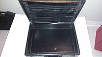 Open black hard case briefcase showing interior card and document slots, lightly used condition.