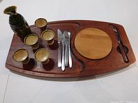 Complete set arranged on the wooden tray: sake jug, 5 cups, 4 butter knives, wooden coaster