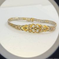 Tri-tone sterling silver bracelet with leaf design and safety clasp shown clearly, highlighting clasp and design details.