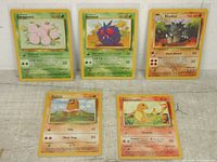 5 basic series Pokémon cards arranged in two rows: Exeggcute, Venonat, Rhydon on top; Diglett and Charmander below.