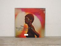 Front cover of the vinyl LP titled 'The Voodoo Drums of Le Gip' showing the side profile of a person with face paint.