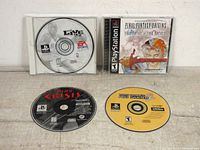 Photo showing all four game discs including NBA Live 97 and Final Fantasy Origins in cases, alongside Dino Crisis and Tony Hawk's Pro Skater 2 discs without cases.