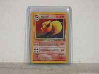 Front view of the holographic Flareon Pokemon Jungle card showing artwork, moves, HP, and stats.