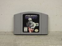 Front of the Nintendo 64 cartridge showing the Star Wars: Shadows of the Empire game label with a Stormtrooper and rating details.