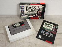 Bass Masters Classic Pro Edition SNES game cartridge, original box, and instruction booklet displayed together.