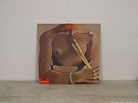 Front cover of the LP showing a shirtless torso holding drumsticks with the album title 'Ego' and artist.