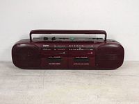 Front view of vintage Sanyo MW-707 radio cassette player showing dual speakers, cassette doors, and handle.