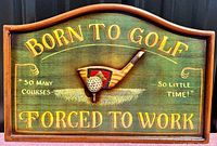 Front view clearly showing the painted text and central 3D golf club and ball detail.