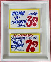 Front view of white wood frame with two sale sign cards under glass.