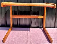 Bottom side view of the table showing the C-shaped leg and horizontal support beam.