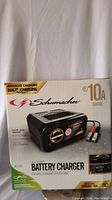 Front of the Schumacher battery charger box showing product image, branding, and 10A charge specification