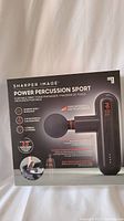 Front view of the Sharp Image Power Percussion Sport massager box showing product image and features.