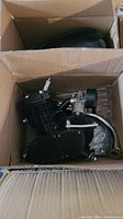 Engine assembly with chain drive, carburetor and hoses inside box