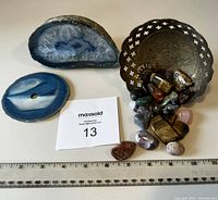 View of blue agate geode, polished slice, brass bowl with tumbled crystals and ruler for scale