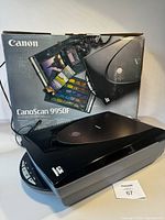 Canon CanoScan 9950F scanner with original box and power cable visible.