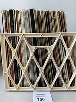 Cream plastic crate filled with vertically stored vinyl LP albums