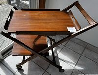 Assembled cart upright showing top detachable tray placed in frame and lower fixed tray. X-frame supports and casters visible