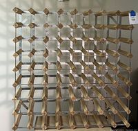 Front-top diagonal view showing full grid of wine compartments made from pine wood and galvanized steel