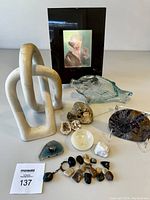 Group photo showing all items including the white wedding knot sculpture, ammonite fossil, geodes, polished crystals, onyx saucer, glass fish with cork, Shakespeare hologram in frame, and dark geode clock.
