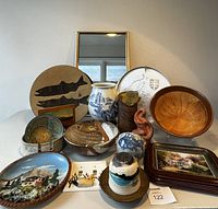 Front view of entire lot showing variety of pottery items, decorative plates, and trays including ceramic vases, bowls, and hand-painted pieces.