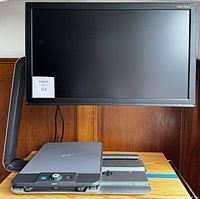 Front view of assembled magnifier showing screen, base, and control panel