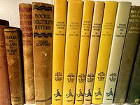 Shelf of Doctor Dolittle hardcovers with gilt titles on yellow cloth spines