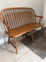 Front left three-quarter view showing armrest, spindle back and turned legs