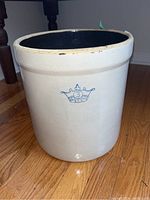 View of the stoneware crock showing exterior with the crown 3 USA blue mark on cream color finish.