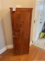 Front view of closed solid wood cupboard