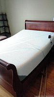 Full view of sleigh bed frame with memory foam mattress and lift foundation