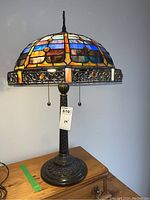 Full front view of stained glass lamp on carved base