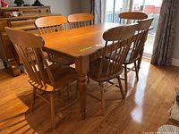 Front-angle view of table and six chairs in room