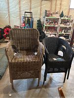 Two wicker chairs side by side, one natural brown and one dark brown/black, showing worn darker chairs missing some color