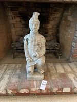 Full front view of the terracotta warrior sculpture showing overall form and paint wear.