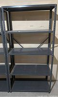 Front view of steel grey metal shelving unit showing full height and four shelves.