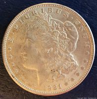 Obverse side of the 1921 Morgan Silver Dollar showing Lady Liberty's profile and inscriptions.