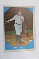 Front view of card showing Babe Ruth batting in Yankees uniform with blue frame