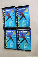 Four unopened 1994 Pinnacle Series 2 foil baseball card packs arranged on a flat surface showing front artwork with silhouette of batter