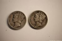 Two Mercury dimes shown side-by-side, front faces visible, worn condition