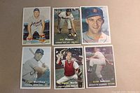 Full set of 6 1957 Topps baseball cards laid out on a beige surface showing players Ron Northey, Frank Bolling, Clem Labine, Vic Power, Mack Burk, and Billy Hoeft with player names and teams visible.