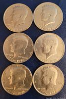 Six 1976 Kennedy half dollar coins heads side showing Kennedy portrait with bi-centennial date 1776-1976