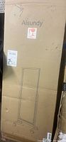 Unopened cardboard box with brand name Aisundy, marked fragile, containing a floor-length mirror on wheels. Box measurements noted approximately 20x65x16 inches.