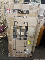 Photo of original packaging box showing the Rikade aluminum extension ladder model XQ-GGT-AL-62 with maximum length 6.2m