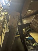 Photo shows stacked boxes with packaging material and parts, less clear view of umbrella fabric.