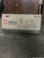 Photo of Huffy EZ Build bike box showing instruction icons indicating no tools are required for assembly