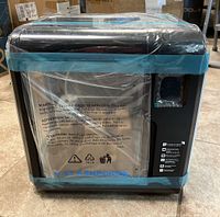 Front of printer in original packaging, sealed with protective film and tape