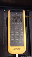 Front view of handheld Dymo XTL300 label maker device with display and QWERTY keyboard.